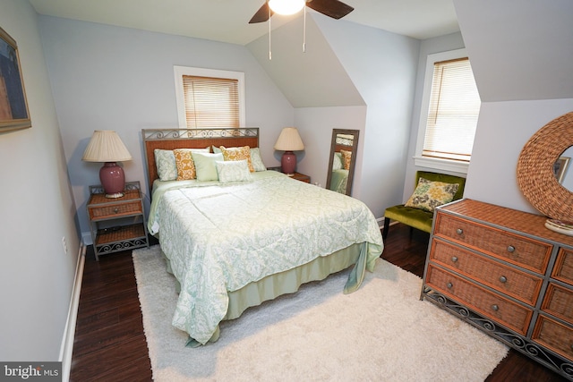 bedroom with ceiling fan, lofted ceiling, and dark hardwood / wood-style floors