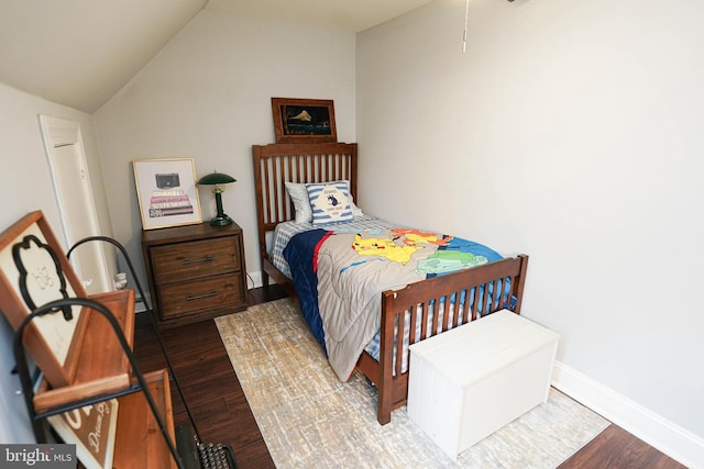 bedroom featuring lofted ceiling and dark hardwood / wood-style floors