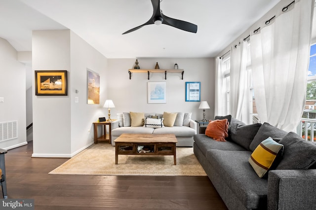 living room with wood-type flooring and ceiling fan