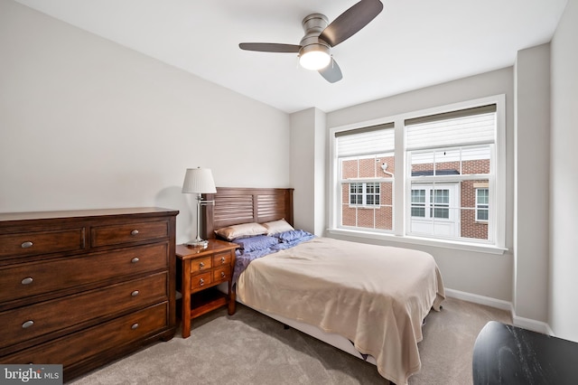 bedroom with ceiling fan and light colored carpet