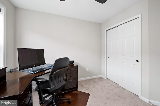 carpeted office space featuring ceiling fan