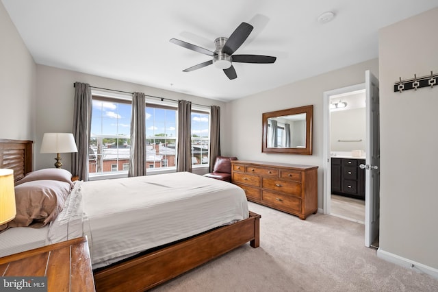 carpeted bedroom with connected bathroom and ceiling fan