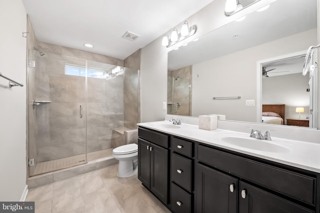 bathroom with vanity, tile patterned flooring, ceiling fan, a shower with door, and toilet