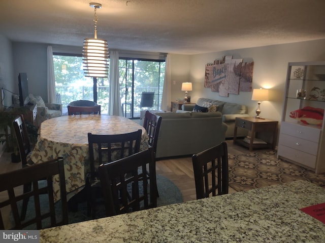 dining space featuring a textured ceiling and parquet floors