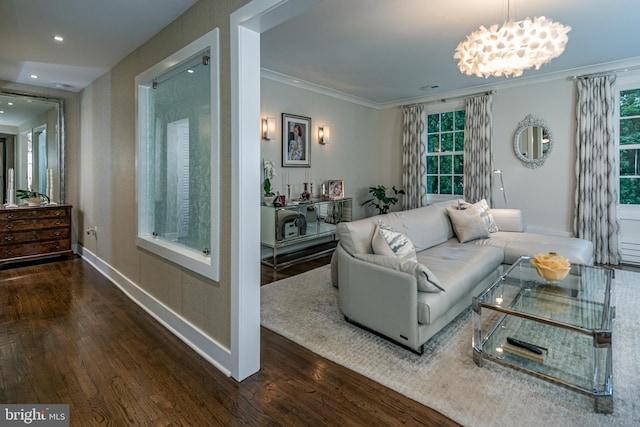 living room with ornamental molding, dark wood-type flooring, and a notable chandelier