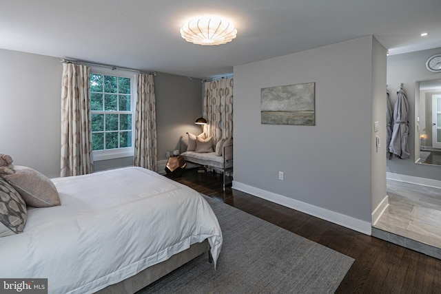 bedroom with dark hardwood / wood-style floors