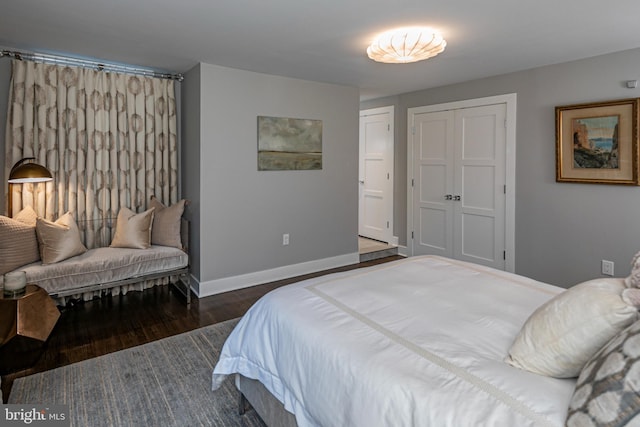 bedroom with dark wood-type flooring