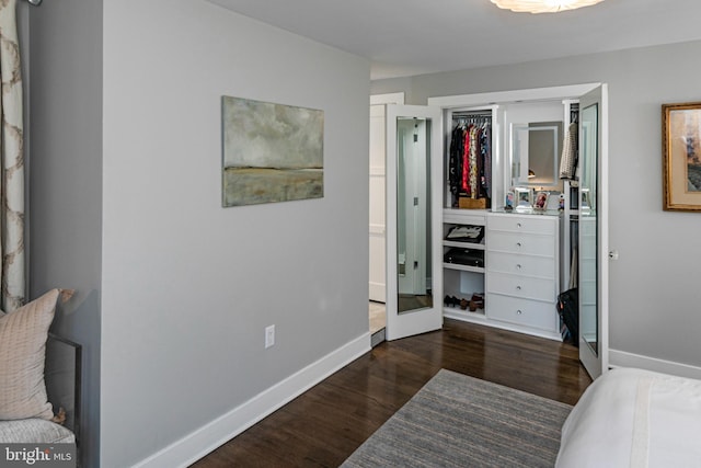 bedroom with dark hardwood / wood-style flooring, french doors, and a closet