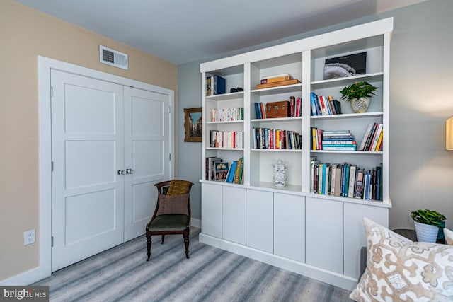 sitting room with light hardwood / wood-style floors