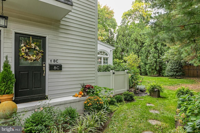 doorway to property with a lawn