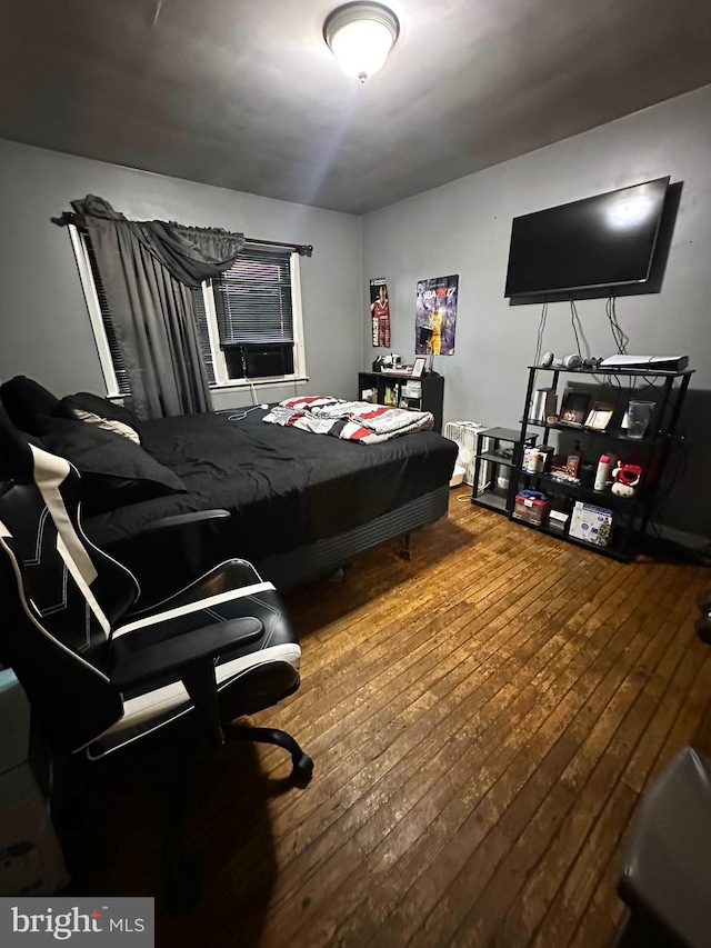 bedroom with wood-type flooring