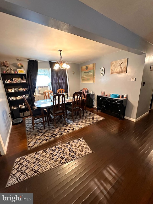 dining room with cooling unit, a notable chandelier, and hardwood / wood-style floors