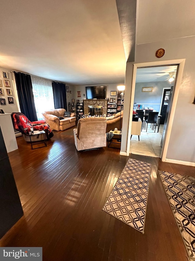 living room with wood-type flooring and a fireplace