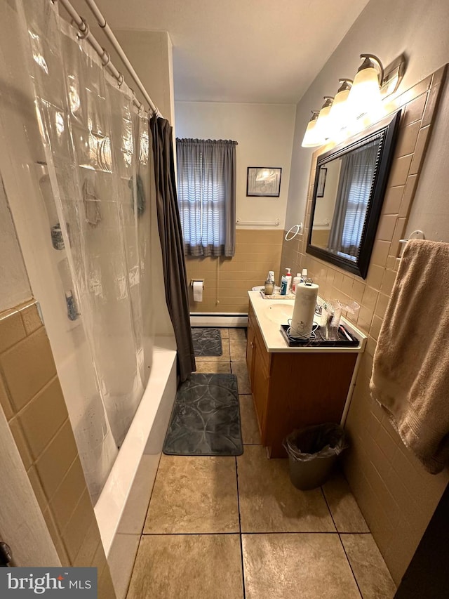 full bathroom with tile walls, vanity, tile patterned flooring, shower / tub combo with curtain, and a baseboard heating unit