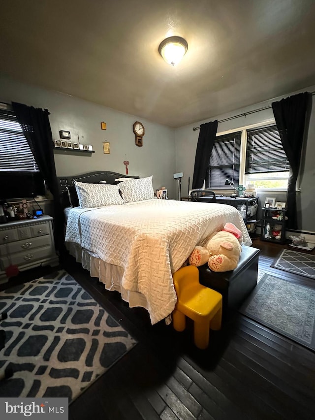 bedroom featuring dark wood-type flooring