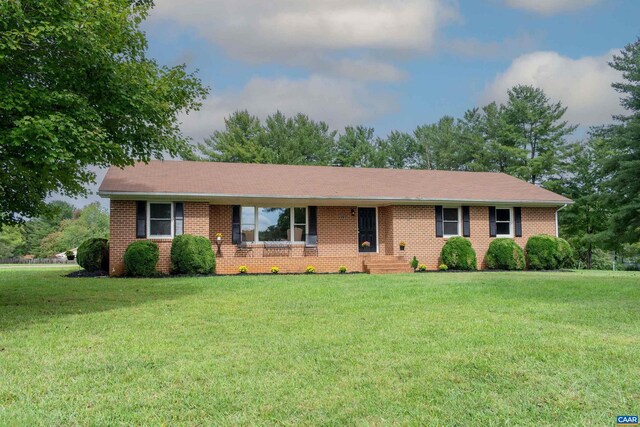 ranch-style home with a front lawn