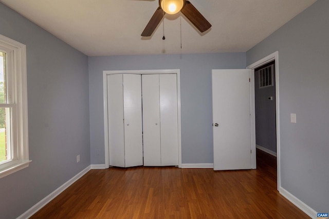 unfurnished bedroom featuring wood-type flooring, ceiling fan, and a closet