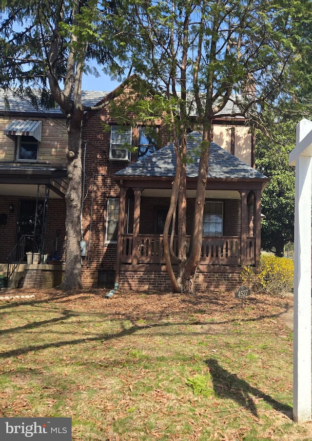 4527 S Dakota Ave NE, Washington, DC 20017 - back of house with a porch, brick siding, and a yard