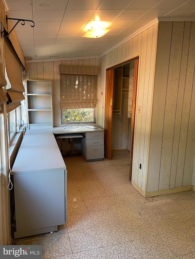 kitchen featuring built in desk and wood walls