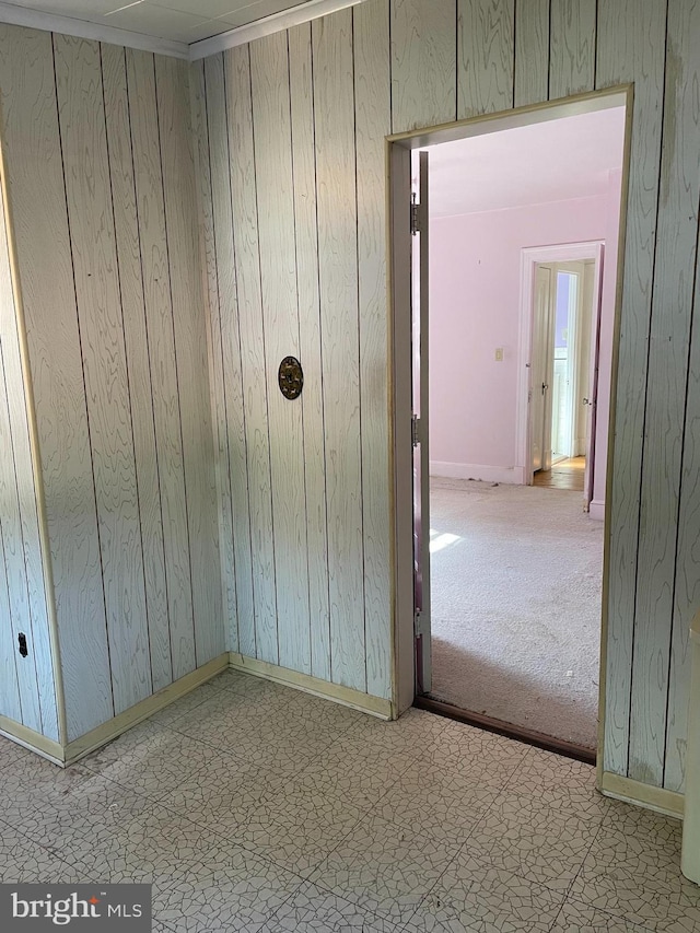 interior space with wood walls and light tile patterned flooring