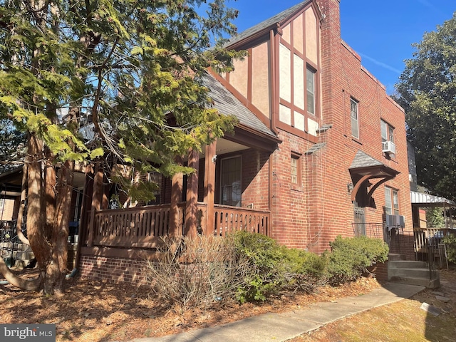 4527 S Dakota Ave NE, Washington, DC 20017 - view of front of property featuring a chimney, cooling unit, stucco siding, covered porch, and brick siding