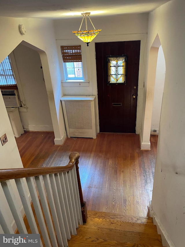 entrance foyer featuring hardwood / wood-style flooring and radiator heating unit