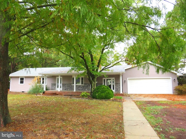 single story home featuring a porch and a garage