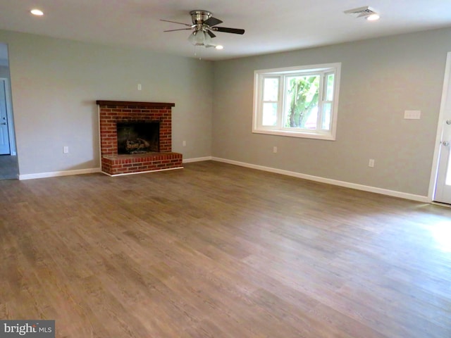 unfurnished living room featuring a fireplace, ceiling fan, and hardwood / wood-style flooring