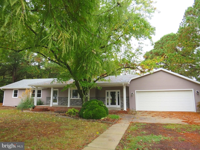 ranch-style home with a porch and a garage