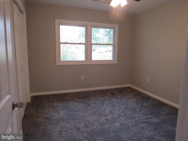 carpeted empty room featuring ceiling fan