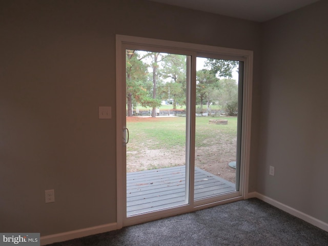 doorway with dark carpet