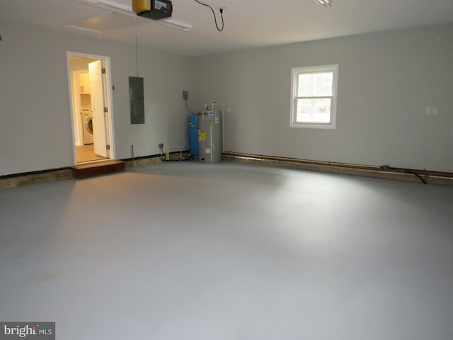 garage featuring a garage door opener, water heater, electric panel, and washer / dryer