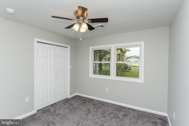 unfurnished bedroom featuring a closet, carpet, and ceiling fan