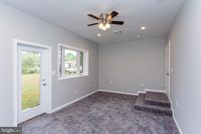 unfurnished room with carpet flooring and ceiling fan