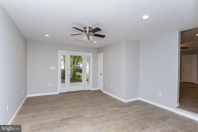 empty room featuring ceiling fan and light hardwood / wood-style flooring