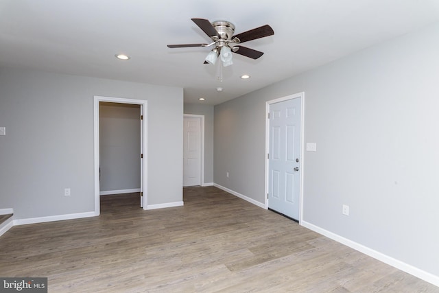 interior space with ceiling fan, light wood-type flooring, a closet, and a walk in closet