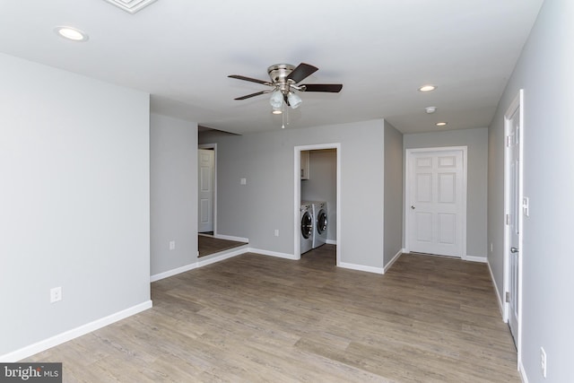 spare room featuring ceiling fan, light hardwood / wood-style flooring, and washing machine and dryer