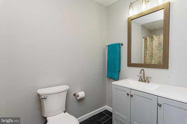 bathroom featuring tile patterned floors, vanity, and toilet