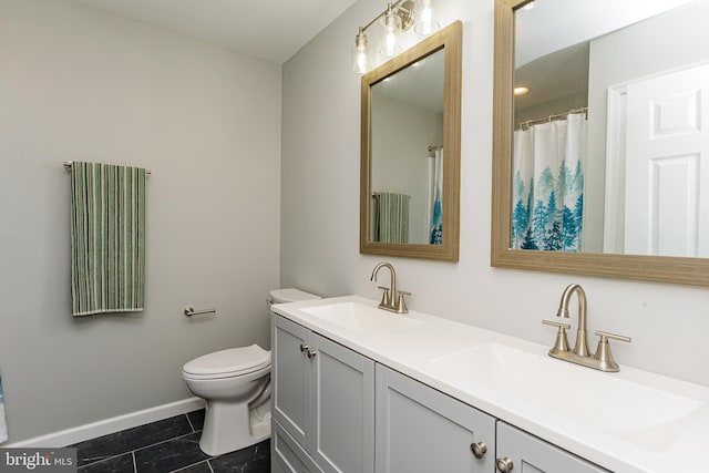 bathroom featuring tile patterned flooring, vanity, and toilet