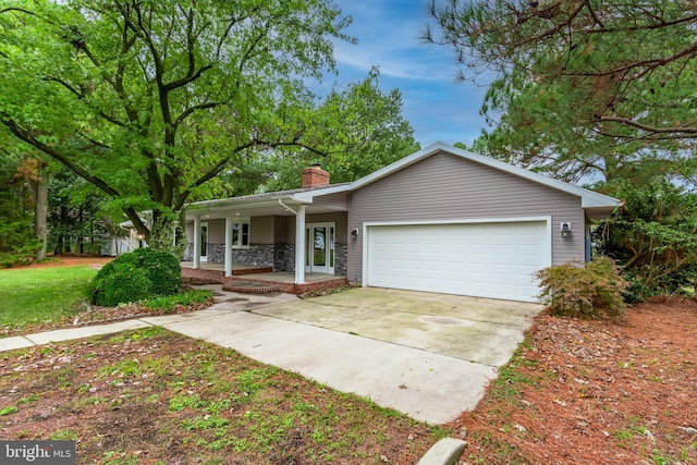 ranch-style house featuring a garage and covered porch