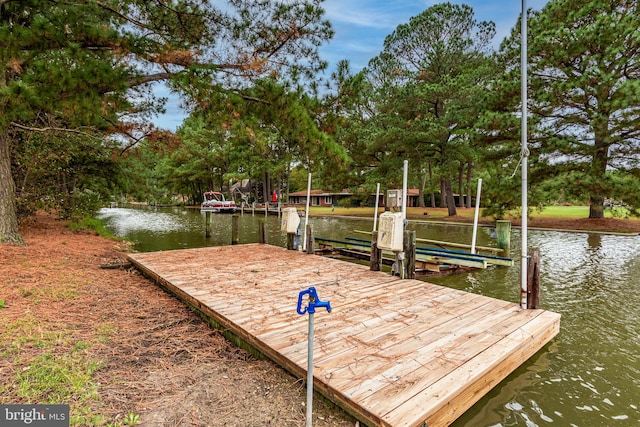 view of property's community with a boat dock and a water view