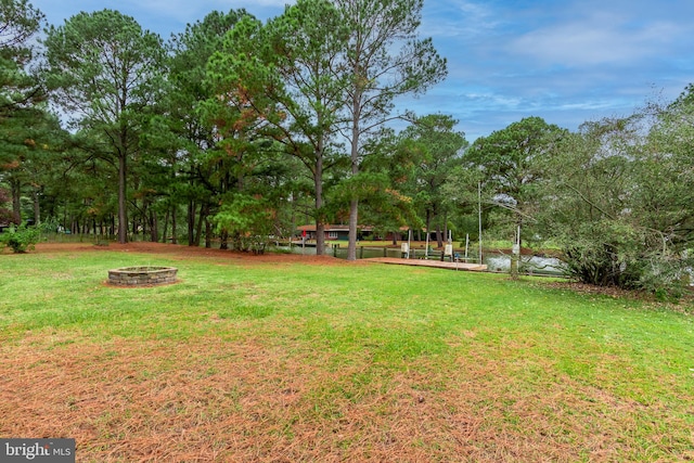 view of yard with a fire pit