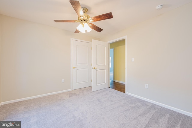 unfurnished room with light carpet and ceiling fan