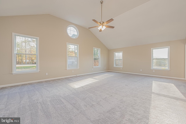 carpeted empty room with high vaulted ceiling and ceiling fan