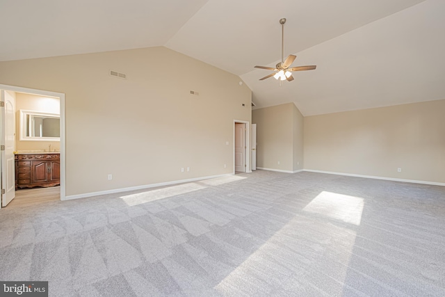 interior space featuring high vaulted ceiling, light colored carpet, and ceiling fan