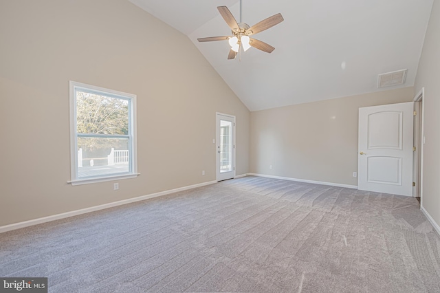 carpeted empty room featuring high vaulted ceiling and ceiling fan