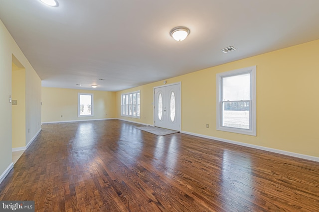 unfurnished room featuring dark hardwood / wood-style floors and french doors