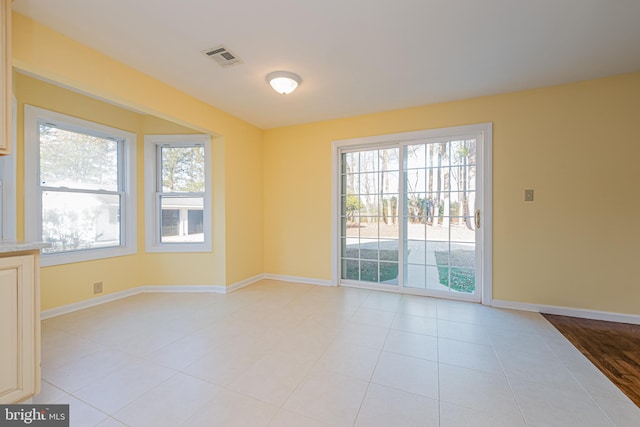 unfurnished room featuring light tile patterned flooring