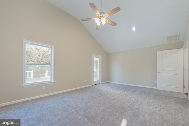 carpeted spare room featuring high vaulted ceiling and ceiling fan