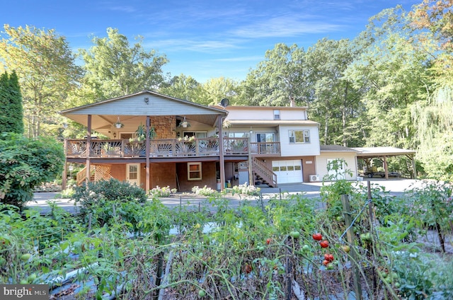 650 Bucks Church Rd, Newport, PA 17074 - back of house with stairway, a wooden deck, an attached garage, driveway, and an attached carport